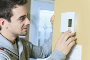 Man Adjusting Thermostat