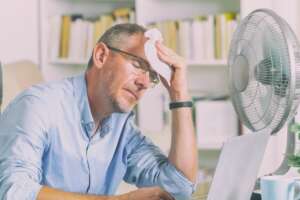 man suffering through AC breakdown